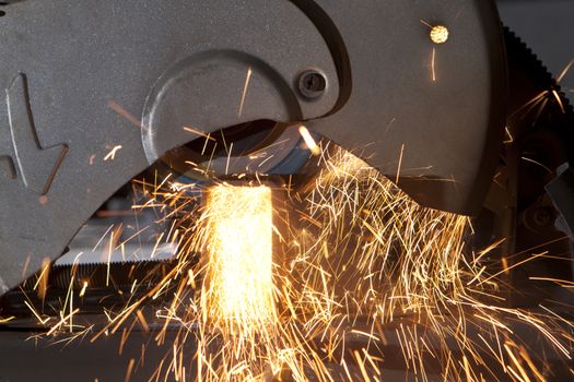 metal cutting saw throwing sparks all over