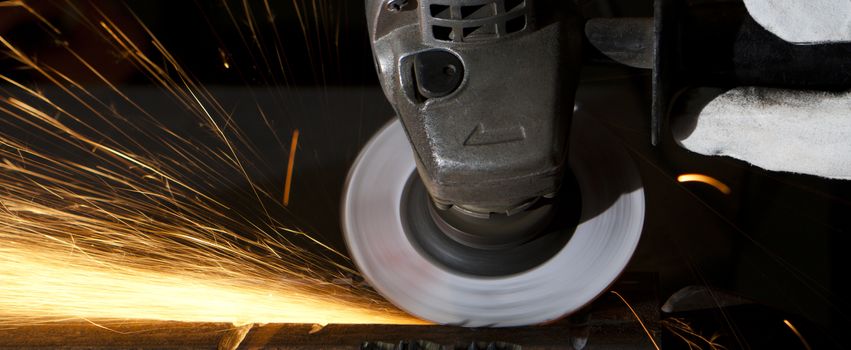 closeup to a grinder sparks all over wide landscape image