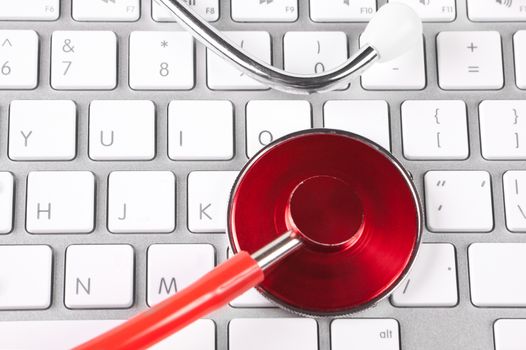 red tehthoscope on new silver keyboard closeup