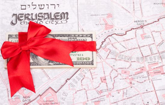 old jerusalem map with dollar and red ribbon