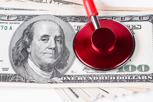examining dollar bills with a red stethoscope on white background