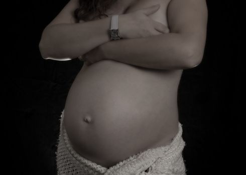 pregnant women belly on black background