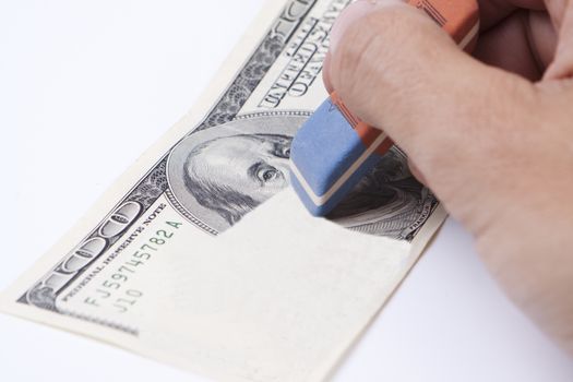 erasing 100 dollar bill with a blue eraser