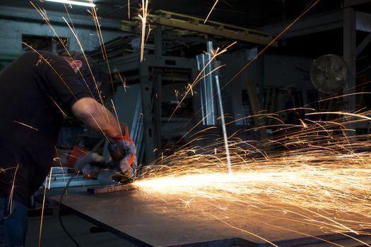 sparks spread all over from an metal grinding action 