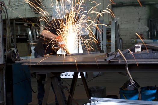 sparks frying over the working table during metal grinding