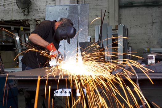 sparks frying over the working table during metal grinding