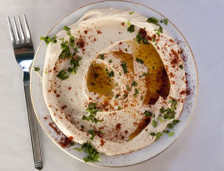 traditional humus dish with olive oil paprika and parsley