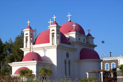 orthodox church  on the shore of sea of galilee blue sky in the background