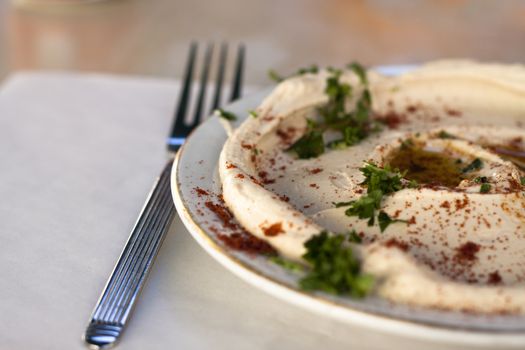 traditional humus dish with olive oil paprika and parsley