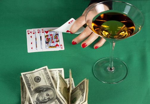 poker cards on green table with dollars