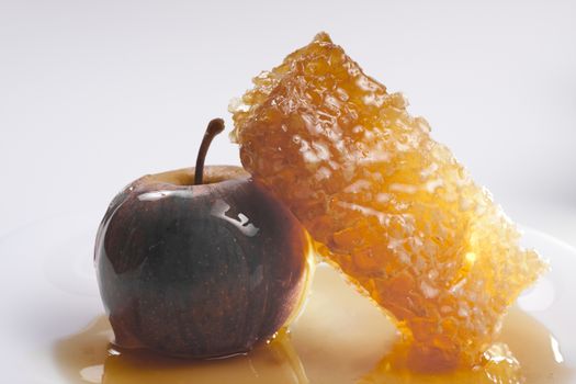 desaturated apple with a honeycomb on white background