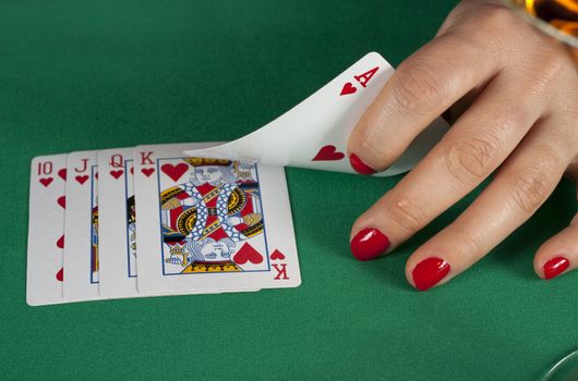 poker cards on green table with dollars