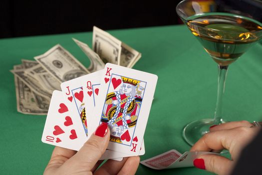 poker cards on green table with dollars