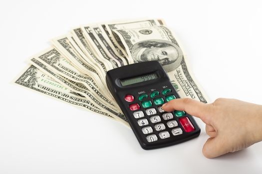 a child calculating expancess on a calculator that stands on  a couple of dollars