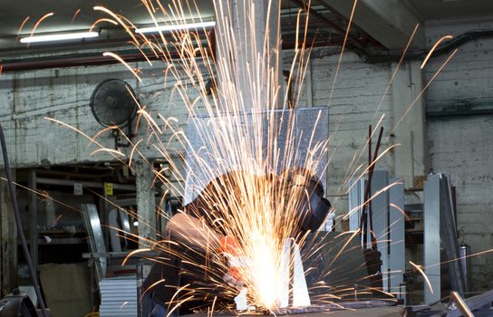 sparks frying over the working table during metal grinding