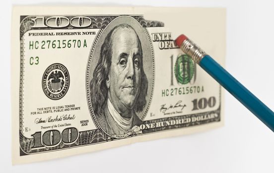 erasing a 100 dollar bill with a blue pencil whith red eraser