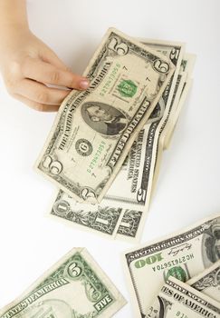 child hand counting dollar bills on white background