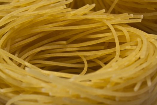 golden pasta nest driyed row close-up macro