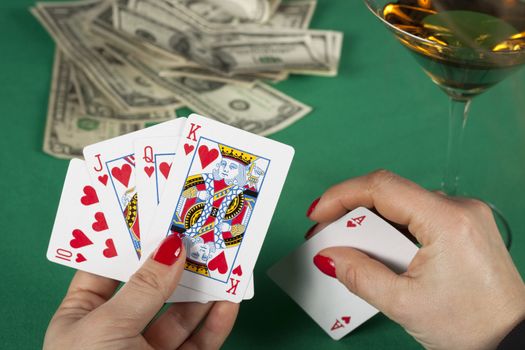 poker cards on green table with dollars