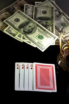 poker playing cards dollars and a wiskey glass