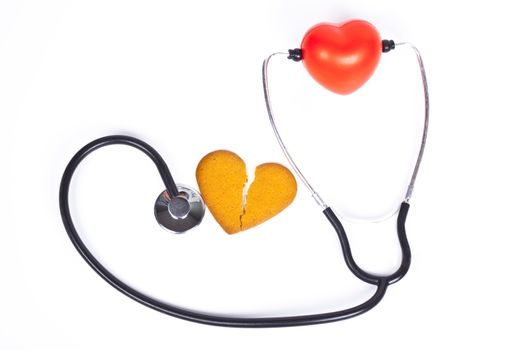 healing a broken heart with  a sthethoscope on white background