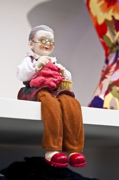 old gramdma decorative wax doll o a white salft corner