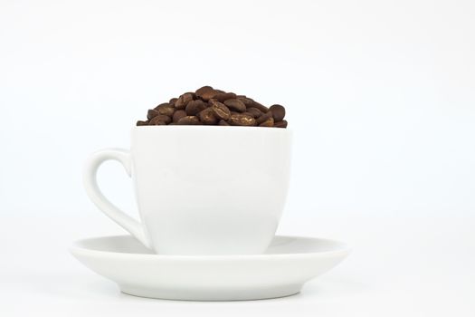 white coffee cup with plat eand coffee beans on white background