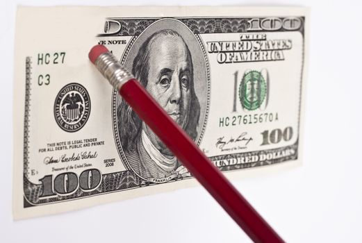 erasing a 100 dollar bill with a red pencil and eraser