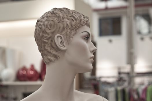 woman manechin with curly hair in a store