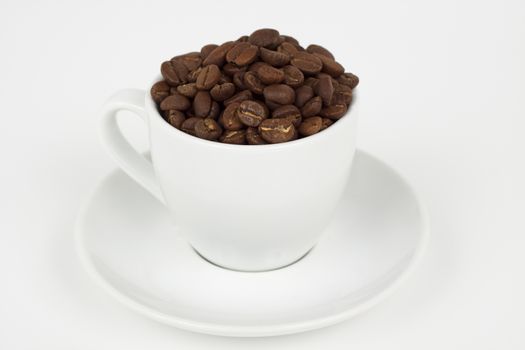 white coffee cup with plat eand coffee beans on white background