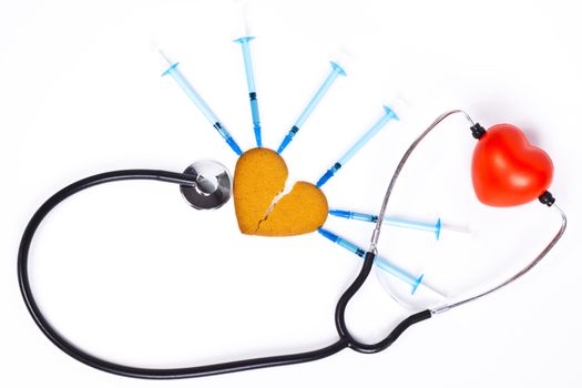 healing a broken heart with blue syringe and a sthethoscope on white background