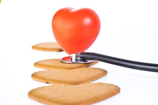 red hart wits a stethoscope  examining brown ginger bred hearts