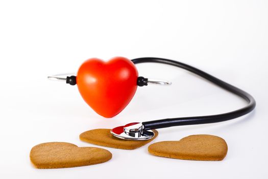 red hart wits a stethoscope  examining brown giger bred hearts