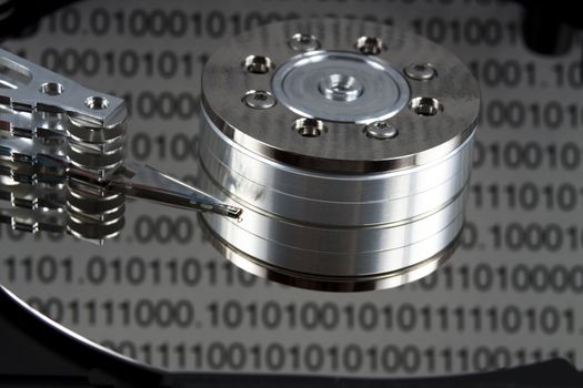 open spinig hard drive closeup on reading head with binary reflected data