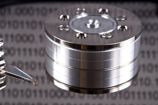 open spinig hard drive closeup on reading head with binary reflected data