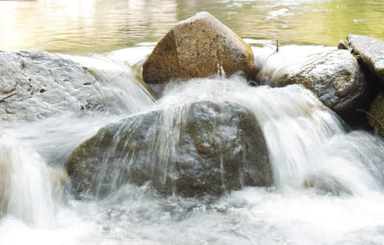 mountain river flow on rocks cascade in the morning light