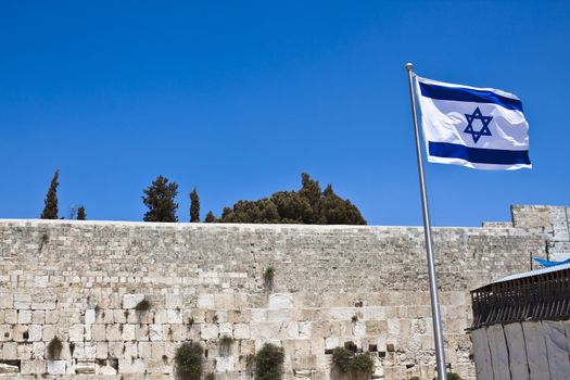 israelian flag with the western wall in the background  and blue sky