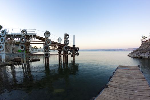 dock's on the sea of galilee at sunset with hte golan hights in the  background 