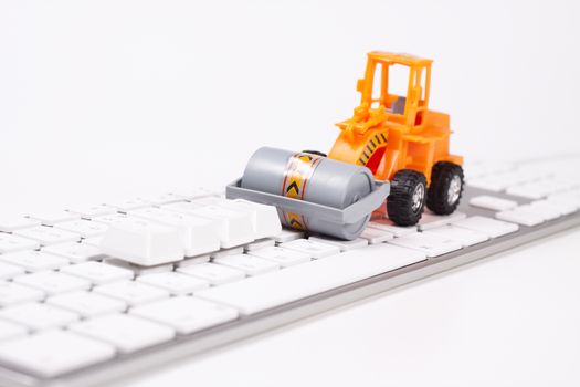 bulldozer flatnening keys on a computer keyboard on white background
