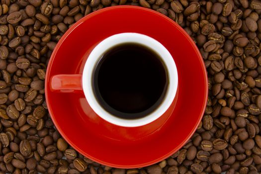 red mug and plate espresso and coffee beans on the background