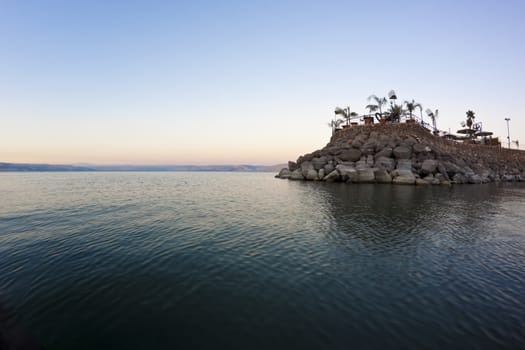 the sea of galilee at sunset with hte golan hights in the  background