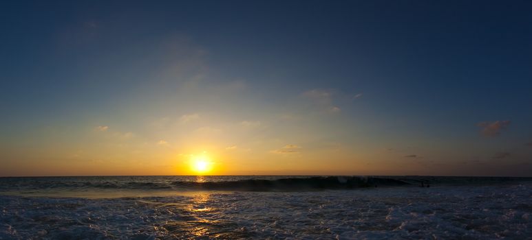 orange sunset with blue sky over the sea with cluods