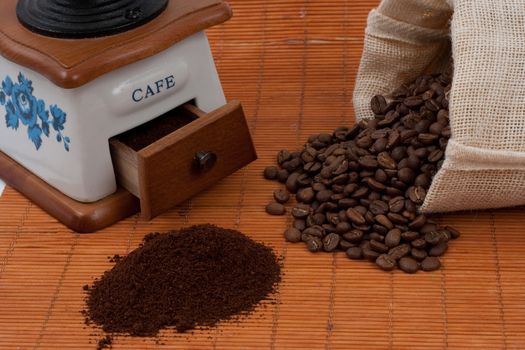 coffee beans from a bag and a grinder