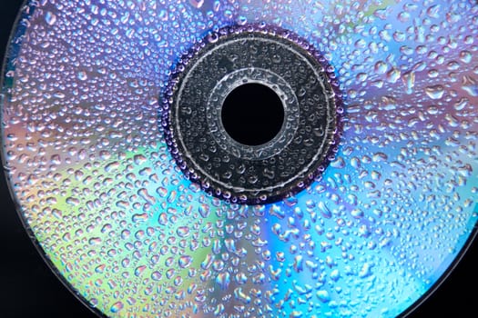 prtial view of a wet cd on black backround