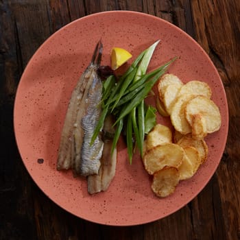 Pacific herring with fried potatoes and onion.