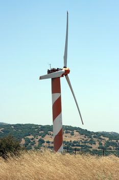 electric power generating wind turbine in the summer