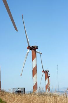 electric power generating wind turbine in the summer