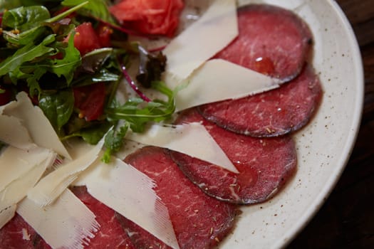 The carpaccio with cheese and salad top view.