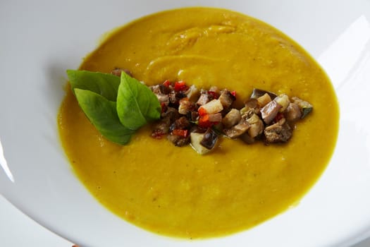 Healthy vegetable cream soup with herbs. Top view