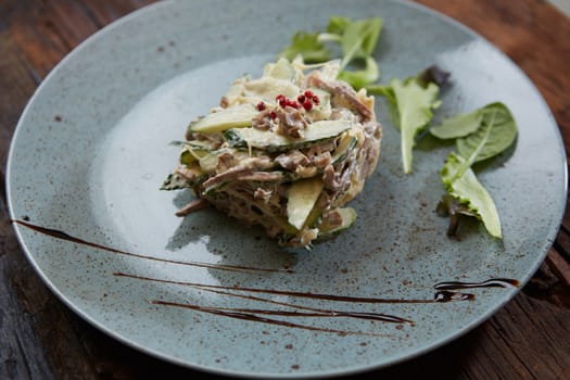 Boiled beef tongue, marinated onion and peas salad with mayonnaise dressing, russian cuisine.